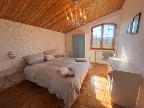a bedroom with a large bed with a wooden ceiling at Ca' di Romagna B&B in Civitella di Romagna