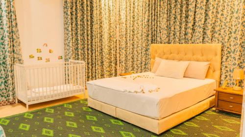a bedroom with a bed and a baby crib at Villa Kimia Elfeige in Marrakesh