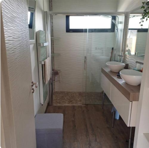 a bathroom with two sinks and a shower at Maison cosy in Grésy-sur-Aix