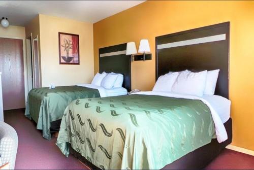 a hotel room with two beds in a room at Urban Inn & Suites in Boise
