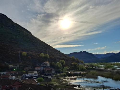 a view of a small town next to a mountain at Lake View Terrace Apartment Dapcevic in Vranjina