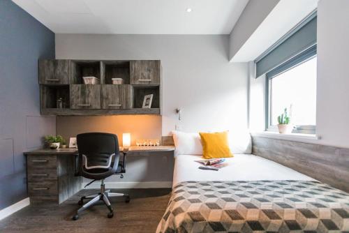 a bedroom with a desk and a bed and a chair at For Students Only - Queen's Court Reading in Reading
