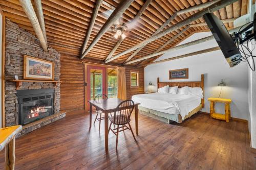 a bedroom with a bed and a fireplace at Lucky Trout Lodge in Heber Springs