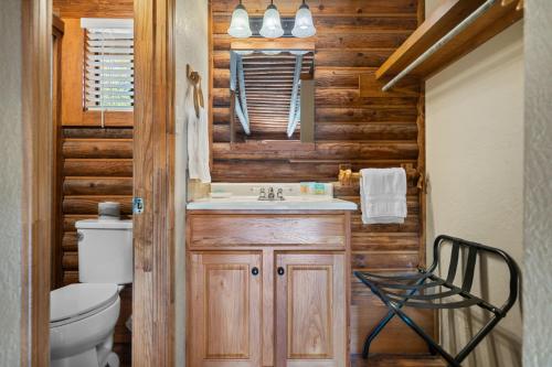 a bathroom with a sink and a toilet at Lucky Trout Lodge in Heber Springs