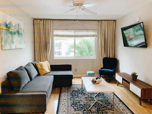 a living room with a couch and a table at Galleria Apartments By Lowkl in Fort Lauderdale