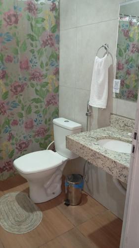 a bathroom with a toilet and a sink at Pousada Venture Jalapao in São Félix do Tocantins
