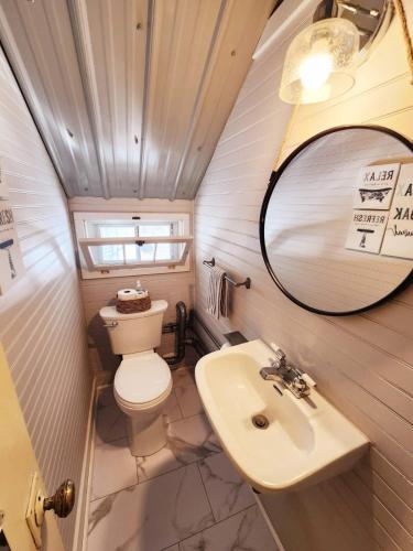 a small bathroom with a toilet and a sink at Oneida Lakeside Retreat in Bridgeport