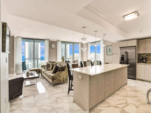 a kitchen and living room with a couch and a table at Luxury 3BR Water view 18th-Floor Deck Pool in Hallandale Beach