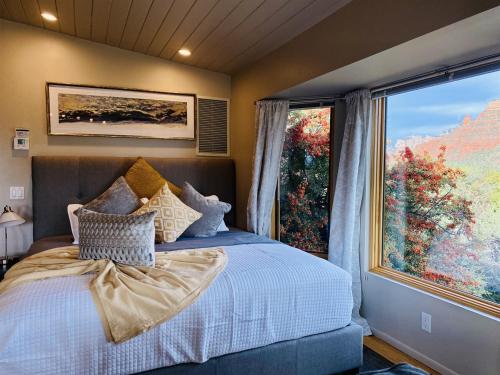 a bedroom with a bed and a large window at Perfect Couples Getaway Private Hot Tub Panoramic Red Rock Views in Sedona