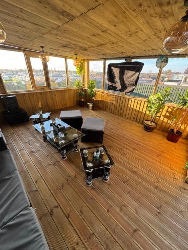 a large living room with wooden floors and windows at Roman apartment in Skegness