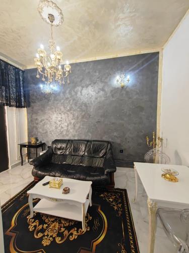 a living room with a couch and a table at Baroque Palace Black Diamond in Arad