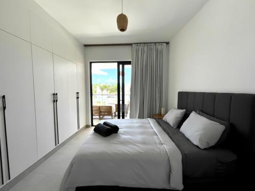 a bedroom with a large bed and a large window at Beachfront Paradise - Huge Pool, Ocean View & Surf in Cabarete