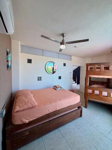 a bedroom with a bed and a ladder in it at Hostal Bucerias in Bucerías