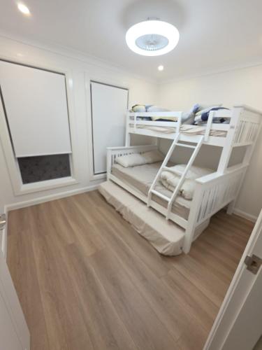 a bedroom with two bunk beds in a room at Serenity Valley Brooklyn in Brooklyn