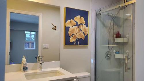 a bathroom with a sink and a shower at Meet Cottage in Vancouver