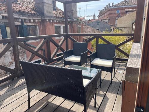a balcony with chairs and a table on a balcony at NEW OPENING San Marco Secret 4343 in Venice