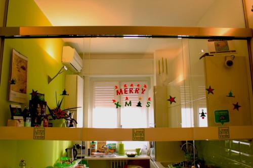 a mirror in a kitchen with amber sign on the window at B&B Linea Verde in Milan