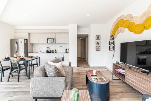 a living room with a couch and a table at Kukun Reforma & Downtown in Mexico City