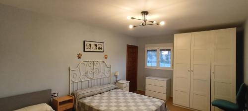 a bedroom with a bed and a dresser at Finca San Diego, villa entera para ti in Vallonga