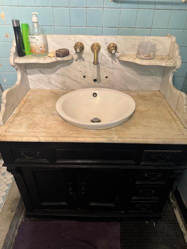 a sink in a bathroom with a marble counter at 15 min Paris in Drancy