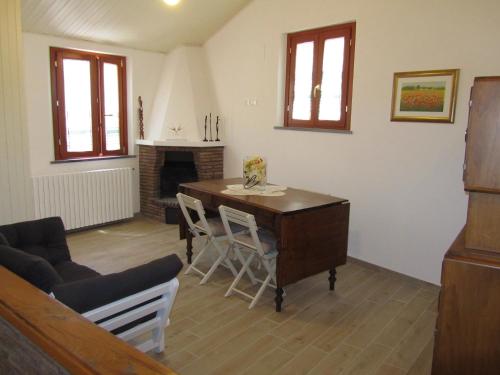 a living room with a desk and a fireplace at Casa Vacanze - B&B La Casetta in Mondolfo