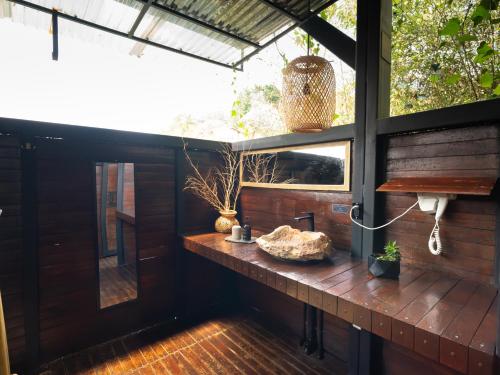a room with a wooden deck with a window at Domus Glamping Guatapé in Guatapé