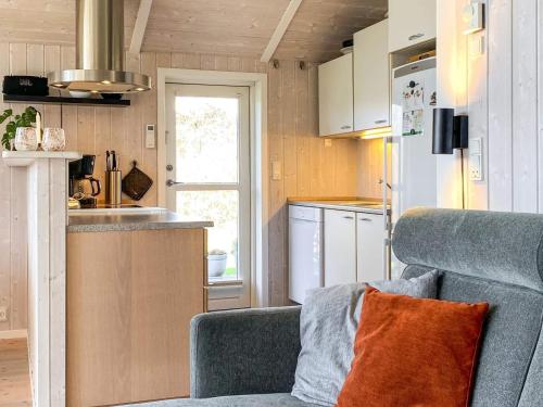 a small kitchen with a couch in a tiny house at 6 person holiday home in Juelsminde-By Traum in Sønderby