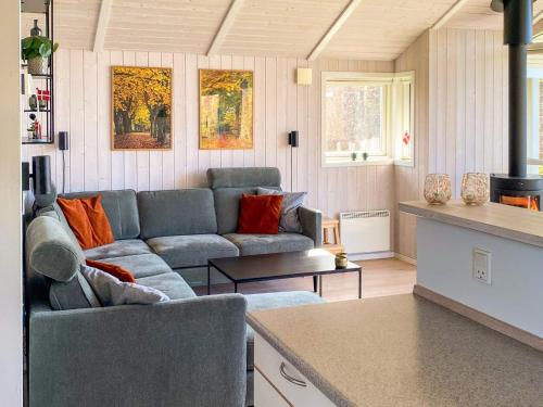 a living room with a couch and a table at 6 person holiday home in Juelsminde-By Traum in Sønderby
