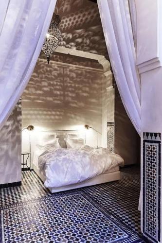 a bedroom with a white bed with a canopy at Riad chak chak suite & spa in Fez