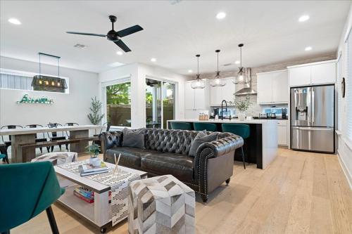 a living room with a couch and a kitchen at Spacious 5BR Central Austin Home Sleeps 13 in Austin