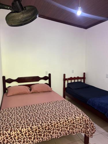a bedroom with a leopard print bed and a lamp at Sítio Pereira in Paraty