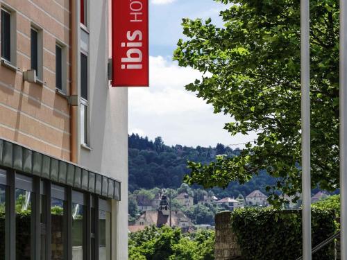 a red sign on the side of a building at ibis Hotel Würzburg City in Würzburg
