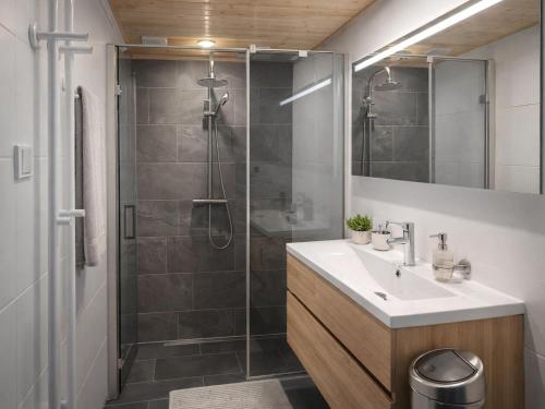 a bathroom with a shower and a sink and a mirror at Wadjuweel in Lauwersoog