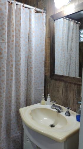 a bathroom with a sink and a mirror at La Posada del Sol in Torres