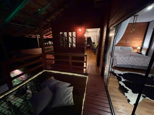 a view of a bedroom with a bed in a room at Cabana Recanto Dona Ilza in Biguaçu