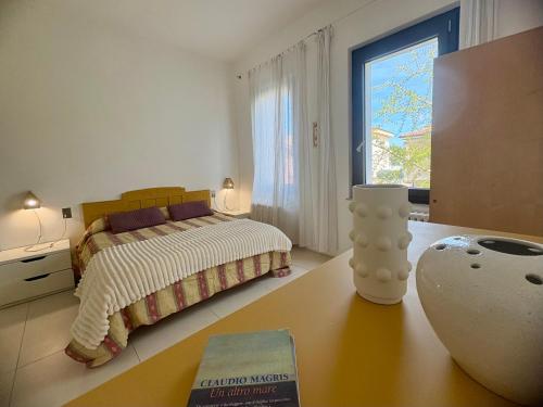 a bedroom with a bed and a table with a book at B&B Glicine in Civitanova Marche