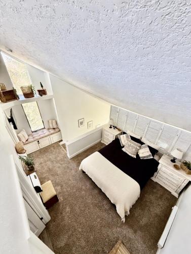 a white bedroom with a bed and a couch at Eagles Roost Haven - Cozy Ski View Condo in Brian Head