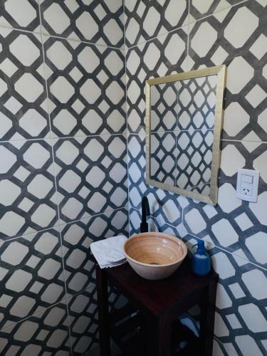 a bowl on a table with a mirror on a wall at Brumas Patagónicas in El Chalten