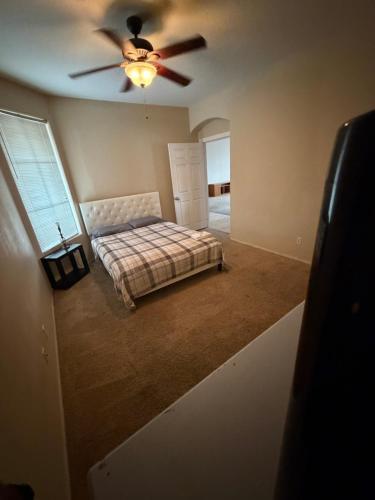a bedroom with a bed and a ceiling fan at Goodyear Cul-de-sac Room 5 in Goodyear
