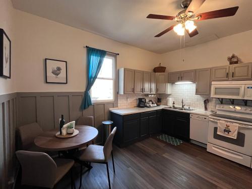 a kitchen with a table and a ceiling fan at Relaxing Townhouse Downtown Dubuque in Dubuque