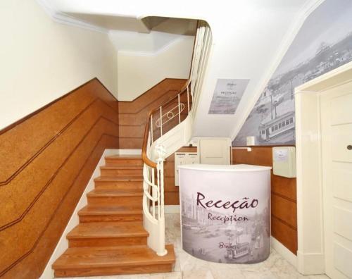 a spiral staircase in a house with wooden floors at BrotherStay Rooms lusotile in Lisbon