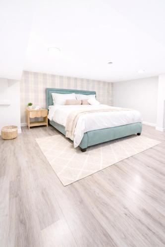 a bedroom with a bed and a wooden floor at Modern Yale Loft Best Location Parking in New Haven