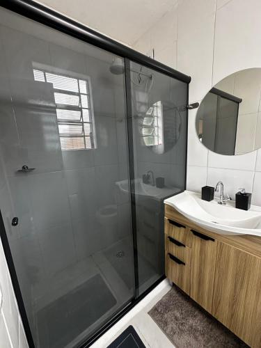 a bathroom with a shower and a sink at CasaMara in Ribeirão Preto
