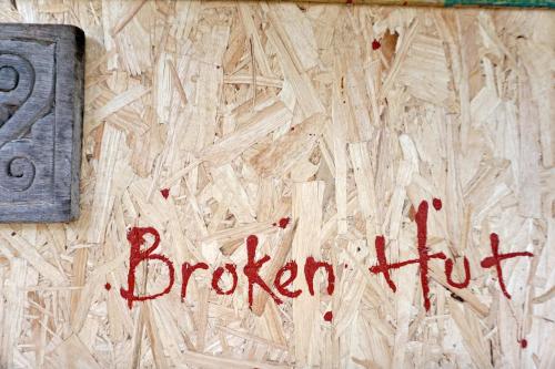 a sign that says broken tofu on a wooden floor at Little hut in Kampong Kundassan