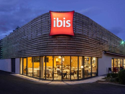 a restaurant with a sign on the side of a building at ibis Nuits Saint Georges in Nuits-Saint-Georges