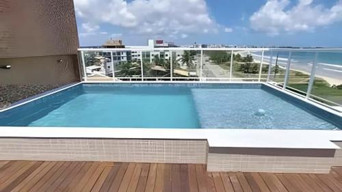a swimming pool on the balcony of a building at Apartment 201 / Oceanfront / Mirrored Bed / Kitchen in João Pessoa