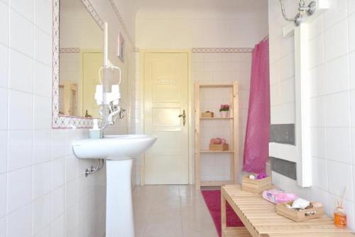 a bathroom with a sink and a mirror at BrotherStay Rooms lusotile in Lisbon
