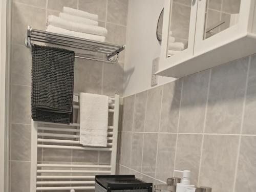 a bathroom with a towel rack and towels at Harbour House Holiday Apartments in Bridlington