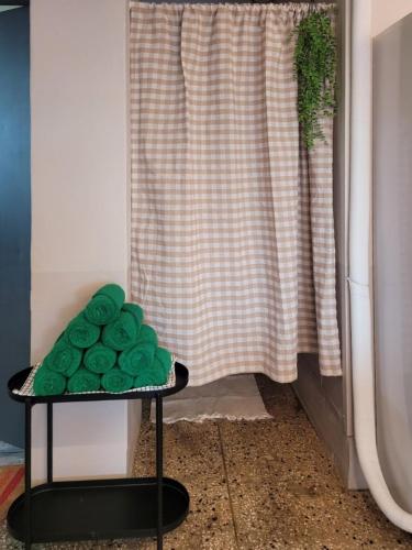 a green plate on a table in front of a curtain at SiSu2 in Chilgok