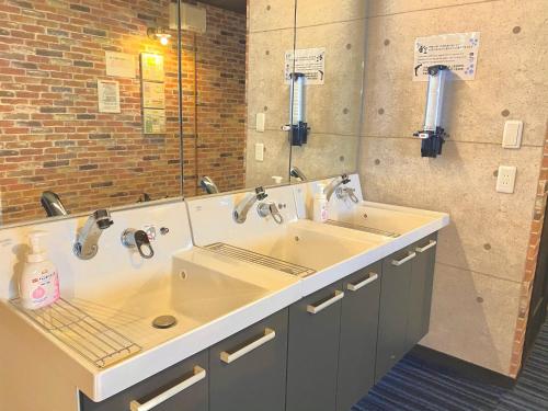 a bathroom with two sinks and a large mirror at Sea Hale - Vacation STAY 7734 in Yuzawa